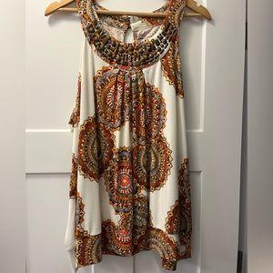 Colorful tank with metal brass beading on the yoke.